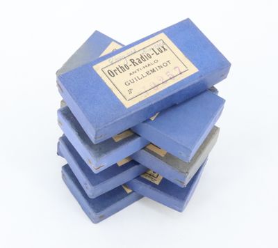 several blue books stacked on top of each other on a white surface