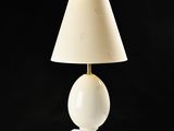 an image of a white table lamp with a beige shade on it