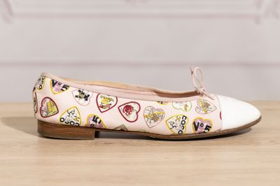 a close up of a pair of shoes with hearts on them