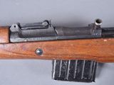 a close up of a rifle on a table with a magazine