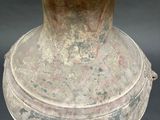 a large vase with a lid sitting on a table