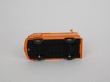 a small orange toy truck on a white surface