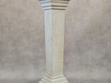 a close up of a white pillar on a gray background