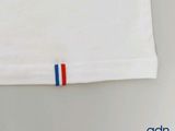 a white shirt with a red, white, and blue stripe on it