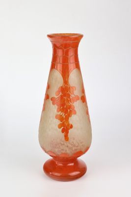 a glass vase that is sitting on a white surface