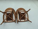 two wicker chairs sitting on the floor next to each other