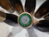 bottles of wine are arranged in a circle on a white surface