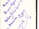 an open book with purple writing on it and a pen in it