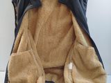 a jacket hanging on a hanger on a white wall