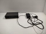 a black box with a cord connected to it on a table