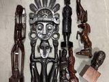 de nombreuses sculptures en bois posées par terre à côté d'une chaise