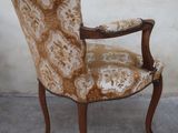 a brown and white chair that is on a concrete floor
