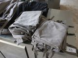 a pile of clothes sitting on a table in a room