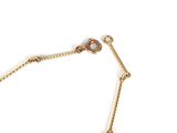a close up of a gold chain bracelet on a white background