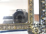 a picture of a mirror with a camera in it