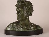 a close up of a bronze bust of a man on a black base