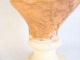 a vase that is sitting on top of a white pedestal