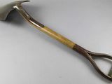a close up of a wooden handled shovel on a white surface
