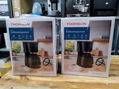 two boxes of coffee makers on a table