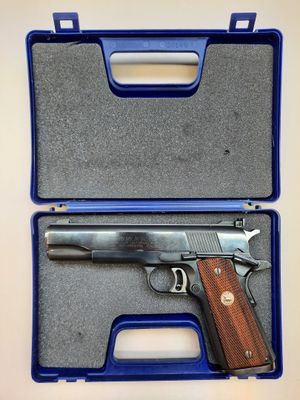 a gun in a blue case on a white surface