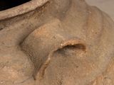 a large clay vase with a hole in the middle of it