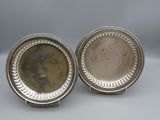 a pair of silver plated dishes with beaded rims