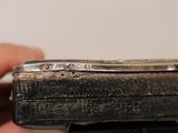 a person holding a small metal object in their hand