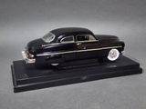 black model of a classic car on a black base