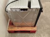 a metal box sitting on top of a wooden pallet
