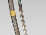 a close up of a pair of swords on a white surface