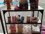 a cart that has various items on it in front of a store