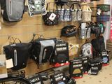 many bags and backpacks on the wall in the store