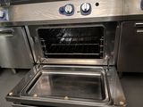 an open oven with the door open in a kitchen