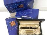 a box with a pen and a notepad inside of it