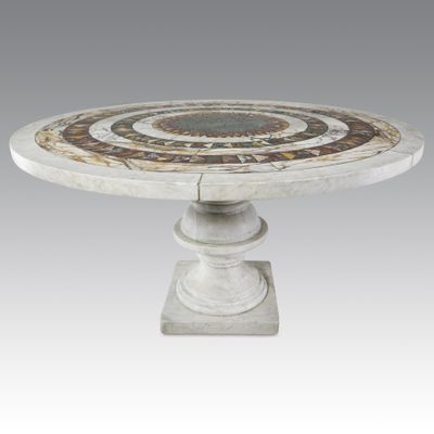 a white marble table with a circular design on top