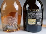 two bottles of alcohol sitting next to each other