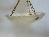 a bird feeder hanging from a chain with a bird on it