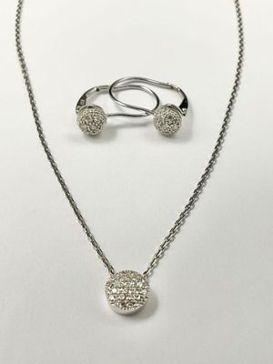 a silver necklace and earring set with a heart shaped pendant