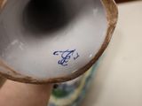 a close up of a vase that has a blue and white design on it