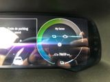 someone is taking a picture of a car ' s dashboard with their cell phone