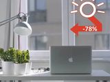 a laptop computer sitting on a desk in front of a window