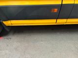 a yellow and black truck parked in a parking lot