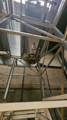 a metal structure with a clock on top of it