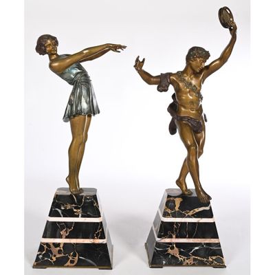 pair of bronze figurines of a boy and a girl on marble bases