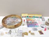 a table with a bowl of beads and other crafting supplies