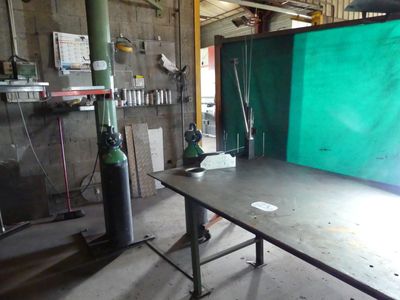 a table with a green screen in the middle of a room