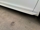a picture of a white car parked on the side of the road