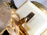 a close up of a gold clock with a clock face on it