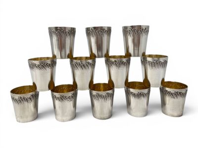 six silver shot glasses are stacked on top of each other