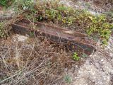a rusted piece of metal sitting in the middle of a field